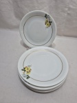 Jogo de 6 pratos de sobremesa em porcelana Renner flor amarela com friso ouro. Medindo 17cm de diâmetro.