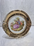 Lindo prato decorativo em porcelana cena galante, borda ouro. Medindo 26cm de diâmetro. Desgaste na douração.