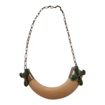 Gargantilha  executada com pedantife em dente de javali encastoada em  metal prateado adornada com quartzo verde, falta uma pedra.