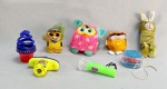 DIVERSOS, sete (7) itens: 2 enfeites em pelúcia para fixação em vidro de carro, um deles faltando parte, medindo o maior 8 cm; 1 brinquedo eletrônico FURBY da HASBRO, modelo Furby Boom, interativo, recursos de animação e voz, medindo 10 cm, não testado e sem garantia; 1 ioió plástico transparente, mecanismo de eixo fixo ou rolamento de esfera simples, desgastes, não testado; 1 pelúcia com mola, representando coelho, interativo, tonalidade verde, medindo 15 cm; 1 mini lanterna led, chaveiro, plastico, tonalidade verde, não testado; 1 peão TWISTER luminoso com lançador, plástico, medindo 14 x 7 cm, encaixe das partes quebrado, não testado, todos os itens com sinais de uso, vide foto.