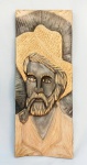 ARTE POPULAR, uma (1) talha representando busto de homem com chapéu fumando cachimbo, para fixação em parede, entalhado em madeira maciça, patina em betume, sinais xilófagos, possui perdas, verso assinado em cavo TICO, medindo 24 x 62 cm, vide foto.