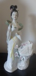 Grupo Escultórico de  porcelana oriental, representando " Pintora oriental " com rica policromia. apresenta pequena perda do dedo da mão. Alt. 33 cm