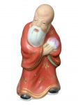 A figura é frequentemente identificada como Shou Xing (ou Shoulao), o deus chinês da longevidade, ou Fukurokuju, uma das Sete Divindades da Sorte com 11 cm de altura