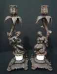 Par de Esplendorosos Candelabro Europeu vitoriano em pesado metal patinado - base com cavalheiro e dama apoiando no tronco, suporte da vela com folhas, sendo que falta uma pétala em um dos candelabro conforme foto, suporta da vela no formato de botão de uma flor. base bem esculpida. Alt. 31cm. Peça muito linda.