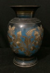 Antigo e pesado vaso oriental de metal com laca escura mesclado com azul celeste com desenhos à cinzel de flores e folhas na galeria central com as bordas sulcadas. Altura 16cm