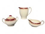 ALFREAD MEAKIN (Inglaterra, 1875-1970), três (3) peças, sendo: A) 1 leiteira, medindo 14,5x16x10cm (marcas do tempo), B) 1 açucareiro, medindo 11x17x10cm (alça colada, fio de cabelo e leves marcas do tempo) e C) 1 molheira, medindo 7x16,5x12cm, confeccionados em faiança inglesa na tonalidade branca, decorados por faixa na tonalidade vinho, guirlanda floral em tom marrom e filete em ouro.