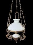 LUSTRE, um (1) lustre para uma lâmpada com estrutura e correntes confeccionados em bronze com rica ornamentação vazada, apresentando elementos de volutas e motivos decorativos de inspiração clássica, cúpula em vidro opalinado, necessita reparo elétrico e fixar uma corrente na canopla, medindo 95x31cm.
