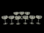 CRISTAIS, nove (9) taças para champanhe confeccionadas em cristal translucido com lapidação de losangos, caneluras, frisos ondulados e horizontais em baixo relevo, haste balaustre apoiada sobre base circular, medindo 12,5x9cm.