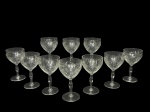 CRISTAIS, dez (10) taças para água confeccionadas em cristal translucido com lapidação de losangos, caneluras, frisos ondulados e horizontais em baixo relevo, haste balaustre apoiada sobre base circular, medindo 15x8,5m.