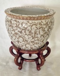 Aquário Oriental em Porcelana vitrificada e policromada com realçes dourados medindo 19 cm de altura por 26 cmde diametro, bom estado de conservação, acompanha peanha em madeira industrializada apresentando desgastes viziveis na foto.