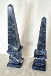 Dois Prismas decorativos em Marmore Azul da Bahia o  maior com minima falta medindo 48 cm de altura por 11 cm por 11 cm e a outra com mais faltas medindo 42 cm de altura por 11 cm por 11 cm..