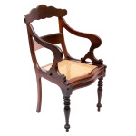 Cadeira de braços em jacarandá, dita "pernambucana". Assento em palhinha natural. Alura do encosto: 96 cm.