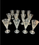 Doze  taças de cristal lapidado da marca HERING, bojo cônico , lapidação dito folha em baixo relevo , haste alongada apoiado sobre pé circular ,  altura  12 cm de altura x 6  cm de diâmetro