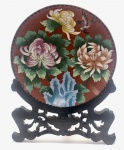 China / Beijing Cloisonné. Belo prato em cor coral decorativo em autêntico Beijing Cloisonné que é associado ao luxo imperial.   Tem valor artístico e histórico. Sobre corpo de cobre são soldados pequenos cloisons que formam o design.  Nos cloisons são preenchidos pigmentos de esmalte. Então o prato é queimado e polido.  São necessárias várias queimas e polimentos.  O prato é decorado detalhadamente com grandes flores de crisântemos e um pássaro em um fundo coral (marrom-avermelhado). É visível, as tiras de cobre que formam os cloisons e percebe-se o relevo. Lindo suporte de madeira é bem entalhado. Século XX. Excelente estado de conservação. Diâmetro do Prato 26 cm. Altura com suporte 37 cm.