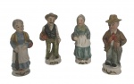 Conjunto de 4 pequenas esculturas em porcelana pintada à mão, representando camponeses em trajes típicos com cestos de frutas e flores. Base circular simples com marca. Um possui sinal de restauro. Medida do maior 12cm.