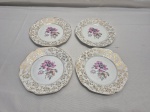 Jogo de 4 pratinhos de fruta, pão em porcelana Mauá floral com detalhes ouro. Medindo 15,5cm de diâmetro. Leve desgaste na douração.