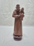 Imagem de Santo Antônio em madeira entalhada, assinado Exp. Medindo 24cm de altura.