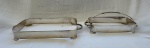 DOIS ANTIGOS SUPORTES DE PYRES EM METAL PRATEADO. MEDINDO O MAIOR 6 X 23.5 X 45 CM E O MENOR 12 X 18 X 33 CM