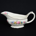 FAIANÇA INGLESA, uma (1) cremeira, ornamentação floral policromada, arremates com frisos a ouro, marcaWOODS IVORY WARE (usada nas décadas de 30 e 40 pela Wood & Sons, fundada em 1865, funcionou na PotteriesNew Wharf em Trent e mais tarde na Pottery Stanley em Burlem, fechou em 2005), medindo 20 cm comprimento, traz ocraquelê característico do envelhecimento de toda a faiança, sinais de uso, vide foto.