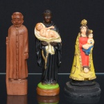ARTE-SACRA, Três (3) imagens religiosas, sendo uma em madeira representando Padre Cícero, com a marca ao fundo F.S e duas em estuque policromado, uma (1) representando Nossa Senhora com o menino Jesus, (Nossa Senhora apresenta pescoço quebrado, colado e apresenta faltas) e uma(1) representando a imagem de São Benedito com menino Jesus. Alt. da Maior 15,5cm e da menor 14cm.