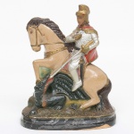 ARTE-SACRA, uma (1) escultura em estuque policromada e esmaltada representando São Jorge. Alt.17cm.