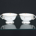 PORCELANA PORTUGUESA, par (2) xícaras de chá descasadas sem os pires, ornamentação floral policromada, arremates a ouro, manufatura VISTA ALEGRE (fundada em 1824, pelo negociante, lavrador, industrial e político, José Ferreira Pinto Basto, através de alvará concedido por D. João VI, tendo seu fundador associado a fábrica os seus 15 filhos, ficando a sociedade denominada Ferreira Pinto & Filhos; cinco anos mais tarde recebe o título real pelo reconhecimento de sua arte e sucesso, ficando conhecida como Real Fábrica da Vista Alegre, começou no fabrico de vidros enquanto se empenhava em esforços para a produção de porcelana, os primeiros ensaios conseguidos foram imperfeitos denominado loiça de pó de pedra, através de boas relações com a fábrica francesa de Sevres conseguiu as receitas para o fabrico de porcelana, somente em 1832, por sorte, é encontrado um jazigo de caulim situado em Aveiro, próximo a Ílhavo, a partir desta data o fabrico de porcelana foi se aperfeiçoando em Portugal, 1851 expôs com sucesso no Palácio de Cristal em Londres; 1852 D. Fernando II visita a fábrica e encomenda uma baixela completa; 1867 recebeu sua primeira premiação na Exposição Universal de Paris; 1880 interrompe a produção de vidros para se dedicar exclusivamente a porcelana; 1964 inauguração do Museu Histórico da Vista Alegre; ainda em funcionamento), ideais para coleção de cristaleira, vide foto.