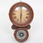 RELÓGIO, um (1) de parede, dito 8, mostrador em papel cartonado com algarismos romanos, portinhola inferior com vidro esmaltado, gabinete em madeira, possui a chave borboleta, falta o pêndulo, medindo 21 cm altura, usado, não testado e sem garantia, vide foto.