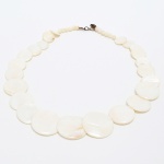 BIJUTERIA, uma (1) gargantilha, confeccionada em discos de madrepérola, dispostos em degrade, além de contas esféricas do mesmo material, monture em metal com sinais de oxidação, fecho do tipo lobster, medindo aproximadamente 44 cm comprimento, sinais de uso, vide foto.