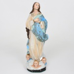 ARTE SACRA. Nossa Senhora da Imaculada Conceição. Imagem sacra executada em estuque moldado e policromado, e olhos de vidro. Apresenta-se em posição ereta, com as mãos cruzadas sobre o peito em sinal de devoção e o olhar voltado levemente para o alto. Traja túnica longa em tonalidade clara e manto azul ornamentado com estrelas e elementos vegetalistas dourados, atributos iconográficos característicos da representação mariana da Imaculada Conceição; composição apoia-se sobre base formada por nuvens, onde se dispõem três cabeças de querubins alados, elemento recorrente na iconografia devocional católica associada à representação da Virgem Imaculada, modelagem evidencia o tratamento das pregas das vestes, bem como dos cabelos ondulados que descem sobre os ombros. Base inferior plana com revestimento em feltro. Apresenta desgastes acentuados, pequena quebradura numa das pontas do manto, visíveis nas fotografias.