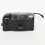 RICOH, modelo RT-550 Date. Câmera fotográfica compacta para filme 35 mm, corpo em material plástico moldado, acabamento preto. Sistema de objetiva retrátil com distância focal variável 35 mm / 70 mm. Visor óptico integrado, com sistema de foco automático e flash incorporado. Painel superior com visor LCD para indicação de data e funções operacionais.Avanço e rebobinamento de filme motorizados. Compartimento posterior articulado para carga de filme. Estado conforme fotografias. Não foi testado, sem garantias de funcionamento.