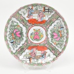 Prato de coleção em porcelana chinesa, decorado com esmaltes da paleta famille rose, com predomínio de tons rosa, verde, vermelho ferroso e dourado. Decoração figurativa com cenas palacianas chinesas, representando personagens trajando vestes tradicionais em ambientes arquitetônicos, alternadas com cartelas florais, insetos e elementos fitomorfos estilizados. Verso com marca em caracteres chineses. Medida: Diam.: