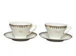PORCELANA SCHMIDT, par (2) de xícaras para chá com seus respectivos pires confeccionados em porcelana nacional na tonalidade branca, decorado por guirlanda vegetalista e filete em ouro e inscrição EU e VOCÊ, medindo 6,5x12x9,5cm, acondiconada em caixa original.