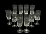 CRISTAL HERING, dez (10) taças flutes confeccionadas em cristal translucido com lapidação de frisos e formas ovais em baixo relevo, haste cilíndrica apoiada sobre base circular, medindo 17x5,5cm.
