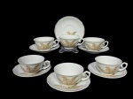 PORCELANA SCHMIDT, seis (6) xícaras para chá com seus respectivos pires, confeccionadas em porcelana nacional na tonalidade branca com pintura de folhagens em monocromia na tonalidade marrom e borda filetada em ouro, medindo 5x11,5x9,5cm, 1 possui defeito de fabricação.