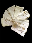 Conjunto com 7 guardanapos em algodão adamascado com monograma não identificado - 45x49 cm - com manchas do tempo.