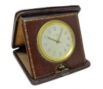 Relógio de mesa com estojo em couro , marca não identificada.( necessita revisão) Med. 10 x 10 cm