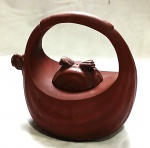 Antigo bule "Yixing" em argila vermelha, modelo de uma bolsa, bojudo e tampa gomados, apresenta carimbo no fundo. Medidas: Alt. 15 x 16 x 11 cm.