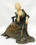 Escultura em bronze e marfim francesa, representando "Donzela sobre Poltrona" numerado na base. 7633 de meados do século XIX  Medidas: Alt.  20 x 19 cm. (Uma das mãos, faltam 2 dedos)