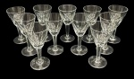 Onze taças para licor em cristal translucido, com decoração gravada e monograma. Medindo: 9,5 x 5 cm.