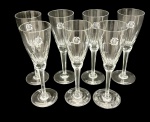 Sete taças de champanhe em cristal translúcido com decoração gravada e monograma. Medindo: 20 x 6,5 cm.
