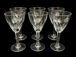 Seis taças de vinho em cristal translúcido com decoração gravada e monograma. Medindo: 16 x 7,5cm.