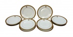 Doze pratos para sobremesa em porcelana, esmaltado na cor branco com elegante faixa superior em em ouro com decoração de arabescos e monograma central. Medindo: 19,5 cm.