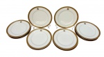 Doze pratos para sobremesa em porcelana, esmaltado na cor branco com elegante faixa superior em em ouro com decoração de arabescos e monograma central. Medindo: 19,5 cm.