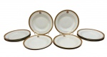 Doze pratos fundos em porcelana, esmaltado na cor branco com elegante faixa superior em em ouro com decoração de arabescos e monograma central. Medindo: 4 x 23 cm.