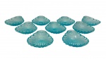 Conjunto de 9 petisqueiras em vidro moldado, em tonalidade azul translúcido, em formato de conchas estilizadas, com relevo radial e bordas onduladas. Medidas aproximadas: 12,5 x 9,5 cm.