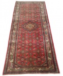 Passadeira caucasiana, Shirvan com rica decoração em padrões geométricos e medalhão central sobre campo vermelho. Medidas: 197 x 83 cm
