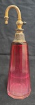 Antigo perfumeiro, confeccionado em cristal em tom  de "rubi " em degradê, com tampa em metal, faltando o borrifador; Medindo 19 x 7 cm