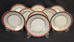 Real, Brasil - Nove pratos de sobremesa em porcelana esmaltada e vitrificada, na cor branca, com borda furta-cor, faixa vermelha e detalhes dourados. Manufatura no verso. Medindo: 19 cm.