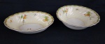 Johnson Bros. England - Duas saladeiras em faiança inglesa com fina decoração floral, guirlandas, borda com frisos verde e dourado. Sobre fundo creme e branco Manufatura no verso. Medindo: 6,5 x 24,5 cm e 7,5 x 23 cm. Craquelê, uma com ínfimo bicado.