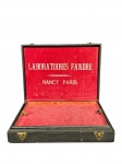 DIVERSOS, um (1) estojo ou maleta de apresentação da Laboratoires Fandre, identificado internamente Nancy / Paris, com exterior revestido em couro na cor preta, interior forrado em veludo vermelho e fechos metálicoxxs frontais. Peça apresentando desgastes, marcas do tempo e sinais de uso. No estado, medindo 8x31,5x23,5cm.
